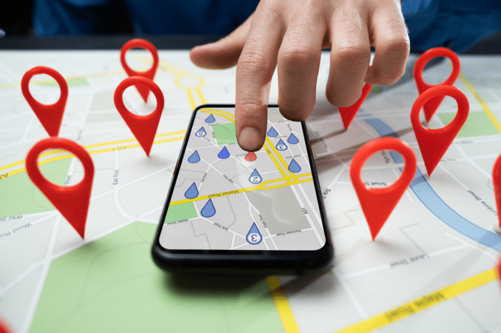 hand tapping on phone screen showing map locations along with 3D visualization