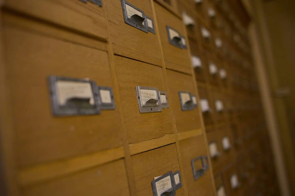 Old wooden library card catalog drawers, representing how searching for answers is changing with AI Overviews
