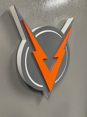 Dimensional VOLTAGE V logo sign on the office wall