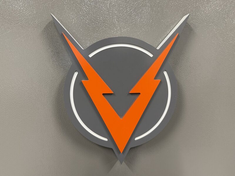 Dimensional VOLTAGE V logo sign on the office wall