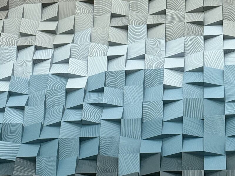 Blue handcrafted wood block art in the VOLTAGE office
