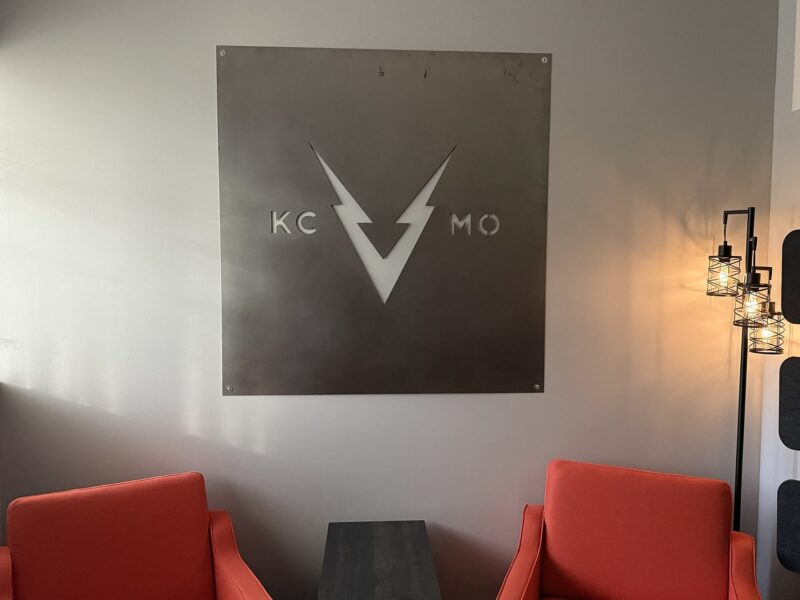 Steel KC V MO sign above orange lounge chairs in the VOLTAGE office