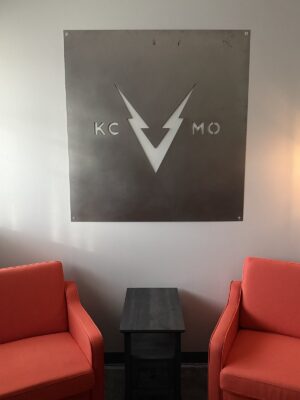 Steel KC V MO sign above orange lounge chairs in the VOLTAGE office