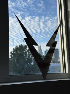 VOLTAGE V cutout in the office window framing the downtown Kansas City skyline